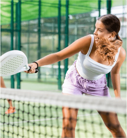 Action shot of girl playing Padel