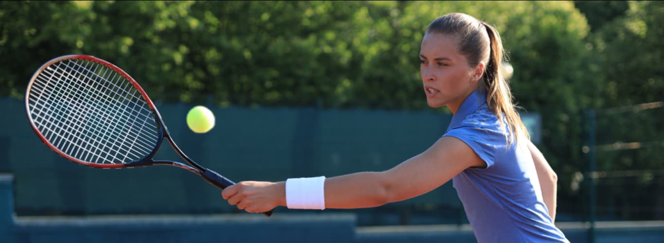 Action shot of sporty girl playing tennis
