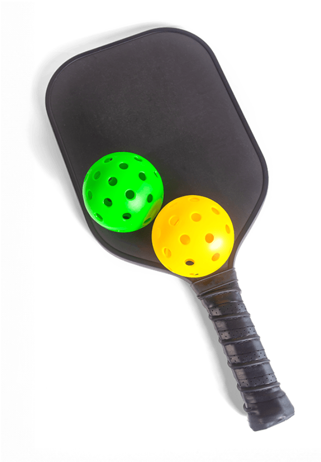 Green and yellow pickleball resting on paddle