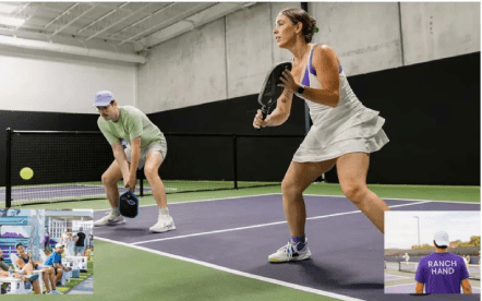 Action shot of two partners playing indoor pickleball at pickleball club