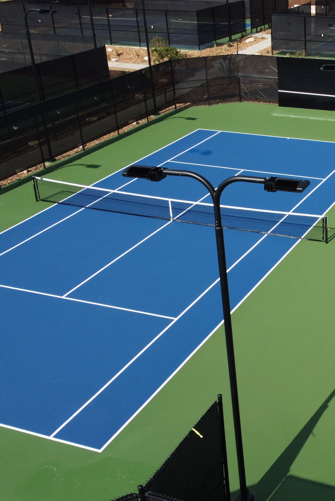 Recreational pickleball court at a park with durable netting and professional-grade surfacing
