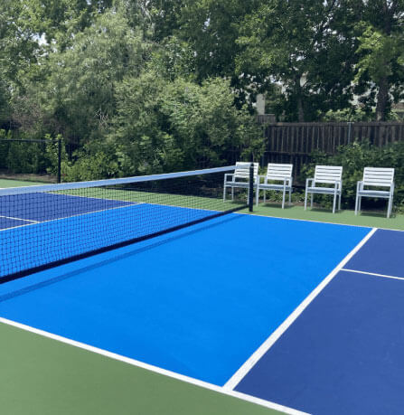 A luxurious backyard pickleball court, seamlessly blending into the surrounding outdoor space.